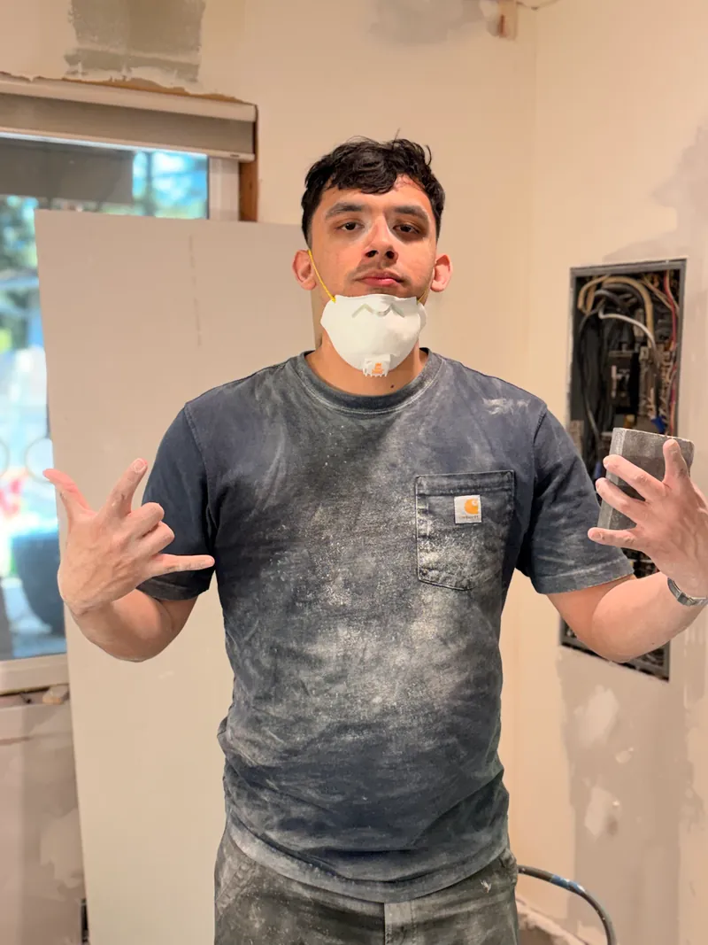 Paulo Pinto-Ramirez in a dusty work shirt on a job site